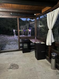 a room with a table and a large window at Cabana Panga in Poiana Aiudului