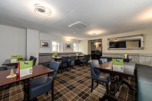 a dining room with tables and chairs in a restaurant at The Kellbank in Gosforth