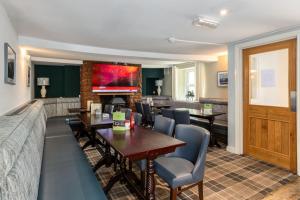 a restaurant with tables and chairs and a bar at The Kellbank in Gosforth
