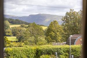 a view of a field and mountains from a house at The Kellbank in Gosforth