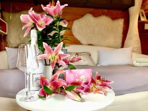 a table with pink flowers on top of a bed at Apartment Berlin | Garden, Terrace, Nature in Berlin