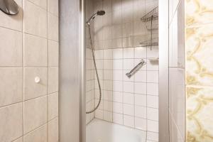 a bathroom with a shower with a glass door at Haus Gisela Berger in Wolpadingen +16 photos