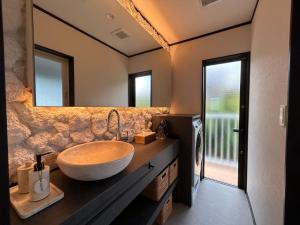 a bathroom with a large sink and a mirror at RetreIto Resort in Ito