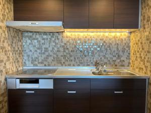 a kitchen with a sink and a counter top at RetreIto Resort in Ito