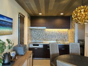 a kitchen with a table and a dining room at RetreIto Resort in Ito