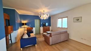a living room with a couch and a chair at Villetta 56 Blu Yellow and Red Lake view Garden Private Parking by Garda Domus Mea in Tremosine Sul Garda