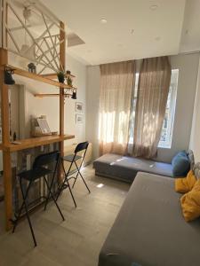 a room with a bed and a desk and chairs at LEO Apartment in Belgrade