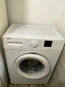 a white washer and dryer in a room at LEO Apartment in Belgrade +20 photos