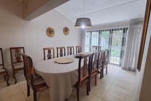 a dining room with a table and chairs at The Wooden Anchor spacious and modern in Zinkwazi Beach