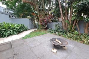 a stone table sitting on top of a patio at The Wooden Anchor spacious and modern in Zinkwazi Beach