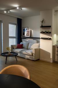 a living room with a couch and a table at Spacious Apartments with Parking by Noclegi Renters in Przemyśl