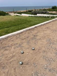 two balls on the ground on a dirt road at Villa La Falaise in Oualidia