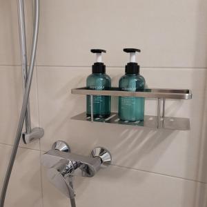 two bottles of water sitting on a shelf in a bathroom at Eifelherz mit Sonnenterrasse in Nideggen +28 photos