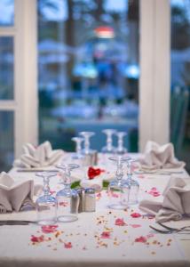 a table with glasses and napkins and flowers on it at Hotel Marhaba Beach in Sousse +37 photos