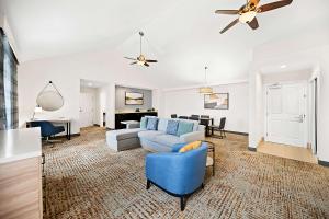 a living room with a couch and chairs and a piano at Hampton Inn Morgan Hill in Morgan Hill