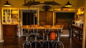 cocina con mesa y taburetes en Milkwood Cottage - Seaview Serenity, en Sedgefield 11 fotos más
