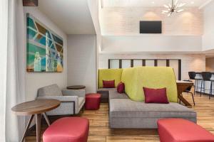 a living room with a couch and a table and chairs at Hampton Inn & Suites Oroville in Oroville