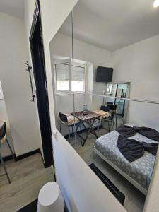 a bedroom with a bed and a table with chairs at ALDEIAS DE SINTRA in Terrugem
