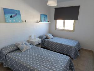 a room with two beds and a window at La Sirena in La Restinga +6 photos