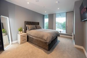 a bedroom with a large bed and a window at City Centre Luxury Apartment In Deansgate in Manchester