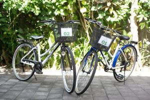two bikes parked next to each other on a sidewalk at Aryma Guest House near Nuanu City, Kedungu Beach and Tanah Lot in Tanah Lot