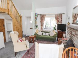 a living room with a couch and a fireplace at Quarry Cottage in Bangor