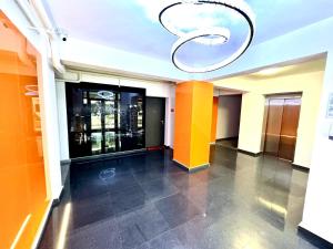 a hallway of a building with a chandelier at QUOVADIS Apart in Otopeni