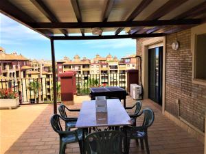 a patio with tables and chairs on a balcony at Alcaudón, Isla Canela - By AC REAL in Isla Canela +66 photos