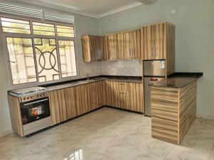 a large kitchen with wooden cabinets and a stove at Zeimet Appartment 2 in Rohero