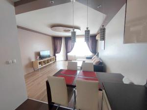 a dining room and living room with a table and chairs at Apartment А13 in Sea Paradise Complex in Kavarna