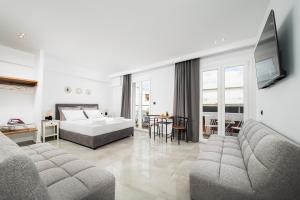 a large living room with a bed and a couch at ELEANA Beach Suites in Limín Khersonísou