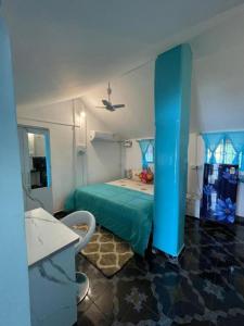 帕特南Villa Del Sol- Patnem Beach Goa的一间卧室配有绿色的床和吊扇