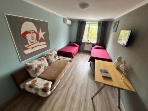 a living room with a couch and a table at Lenin Guest House & Tours in Tiraspol