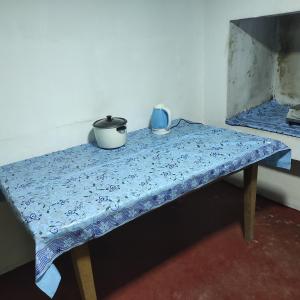 a table with two pots sitting on top of it at Asal Villa in Walliwala East