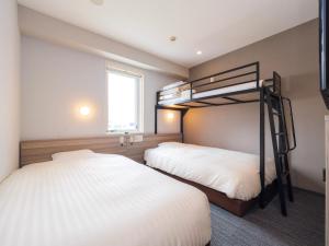 Postel nebo postele na pokoji v ubytování Super Hotel Yokohama Kannai + 37 fotografií