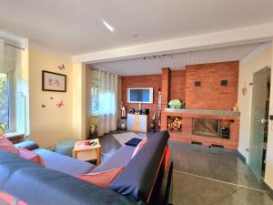 a living room with a blue couch and a fireplace at Haus Kalle in Harlesiel