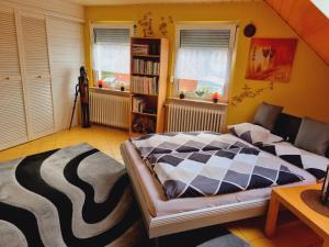 a bedroom with a bed and a book shelf at Haus Kalle in Harlesiel