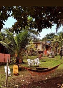 a hammock with two plastic animals on it in a yard at Zion camping in Camacari