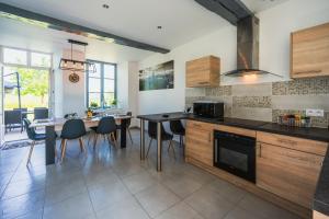 a kitchen with a table and a dining room at Les gîtes Saint-Aignan in Saint-Aignan