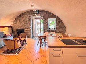 a kitchen and dining room with a stone wall at La Vigneronne, Chailly-Montreux in Montreux