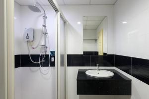 a bathroom with a shower and a sink at 2R2B Seaview Serenity 1 to 8pax Gurney Mansion One in George Town +18 photos