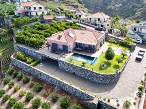 an aerial view of a house with a stone wall at Villa Livramento in Ponta do Sol