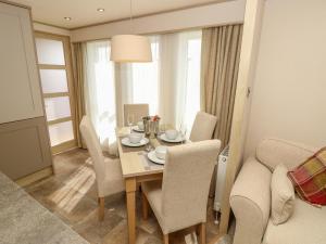 a dining room with a table and chairs at The Boathouse in Chichester +13 photos