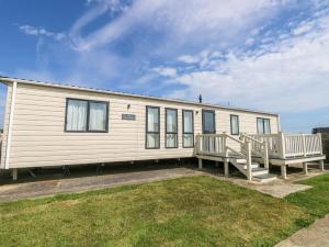 a mobile home with two decks and a yard at The Boathouse in Chichester