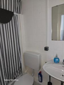 a bathroom with a black and white shower curtain and a toilet at Paulibude in Hamburg +84 photos