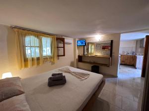 a bedroom with a bed with a bag on it at THE FLOWER APARTMENTS in Toroni