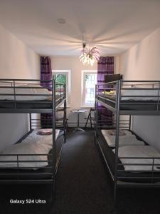 a room with three bunk beds and a window at Paulibude in Hamburg