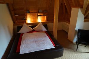 a small bedroom with a bed with two pillows at Ferienwohnungen am Bullachberg in Schwangau