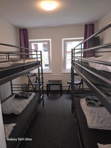 a room with three bunk beds and a table at Paulibude in Hamburg +82 photos