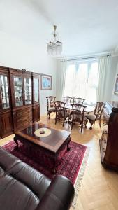 a living room with a couch and a table and chairs at Cozy apartment in the city centre in Olomouc